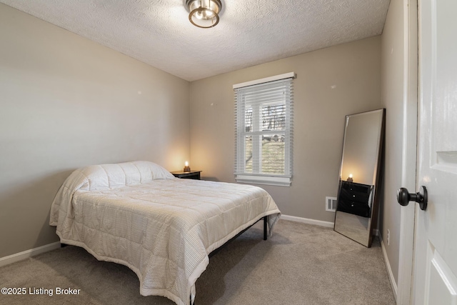 bedroom featuring visible vents, light colored carpet, a textured ceiling, and baseboards