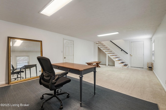 carpeted office space with baseboards