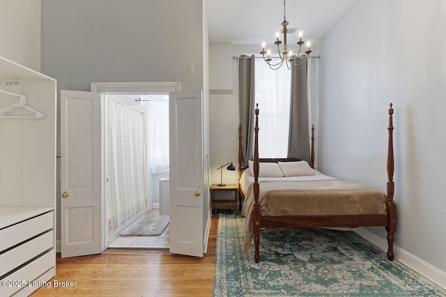 bedroom featuring a chandelier and light hardwood / wood-style floors