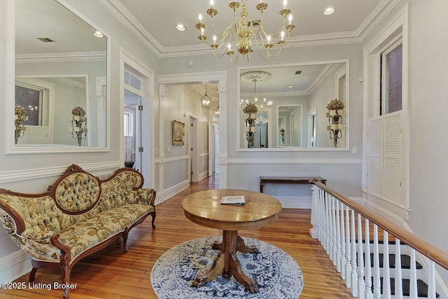 sitting room featuring crown molding, a chandelier, and wood-type flooring