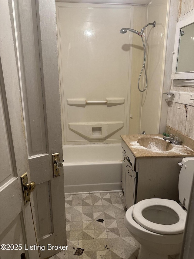 full bathroom with toilet, vanity, and shower / washtub combination