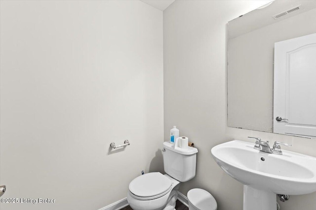 bathroom featuring toilet and sink