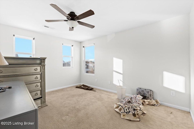 misc room with ceiling fan and light colored carpet