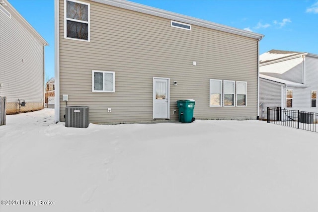 snow covered back of property with cooling unit