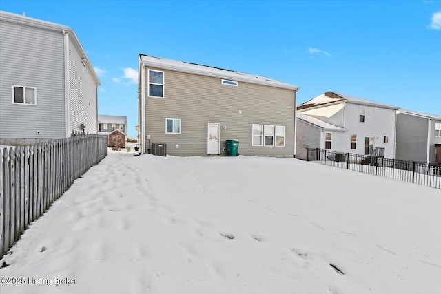 view of snow covered back of property