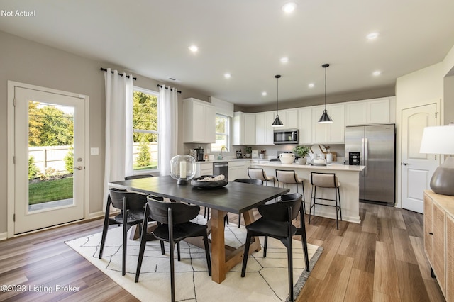 dining room featuring sink and light wood-type flooring