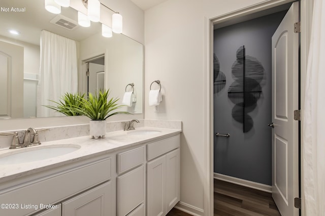 bathroom featuring vanity and wood-type flooring