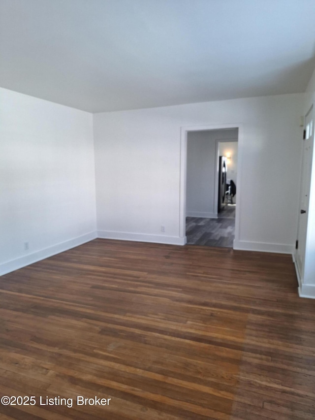 spare room featuring dark hardwood / wood-style floors