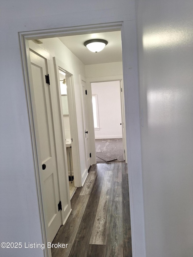 hallway with dark hardwood / wood-style floors