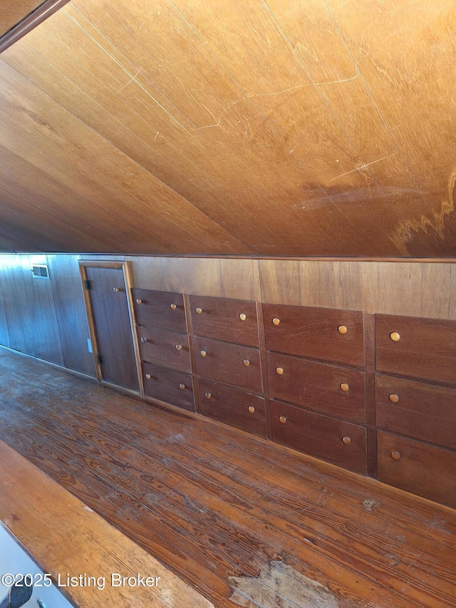 bonus room with wood walls, dark hardwood / wood-style flooring, wood ceiling, and vaulted ceiling