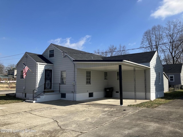 exterior space with driveway and an attached carport