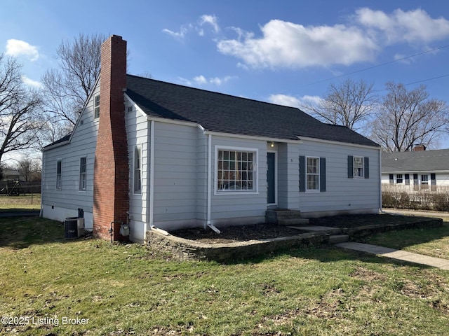 view of front of property featuring a front yard, cooling unit, a chimney, and roof with shingles