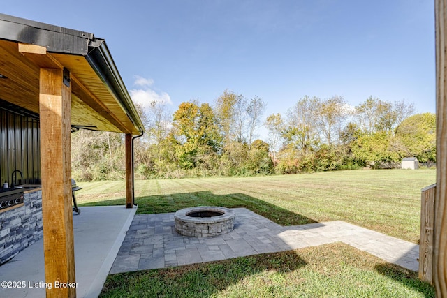 view of yard with an outdoor fire pit and a patio