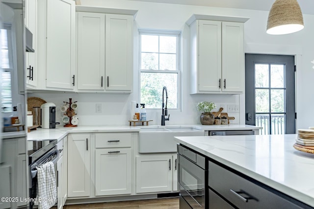 kitchen featuring electric range and white cabinets