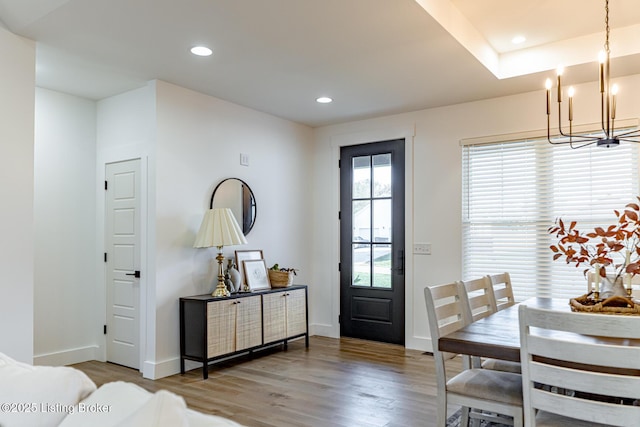 foyer featuring hardwood / wood-style flooring and a notable chandelier