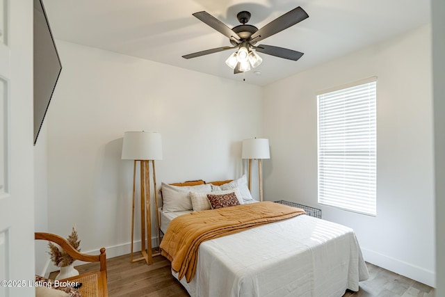 bedroom featuring radiator, ceiling fan, and light hardwood / wood-style floors