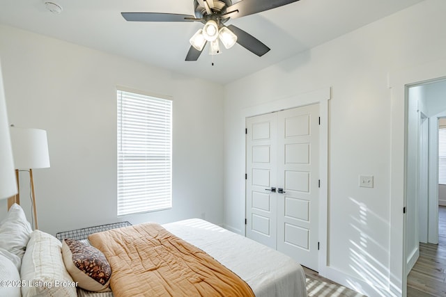 bedroom featuring ceiling fan, a closet, and light wood-type flooring