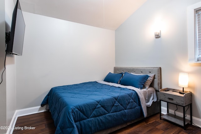 bedroom featuring lofted ceiling and dark hardwood / wood-style floors