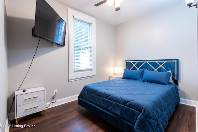 bedroom with ceiling fan and dark hardwood / wood-style flooring