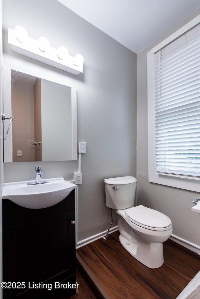 bathroom featuring hardwood / wood-style floors, vanity, and toilet