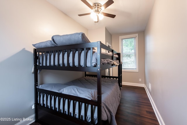 bedroom featuring ceiling fan, dark hardwood / wood-style flooring, and lofted ceiling