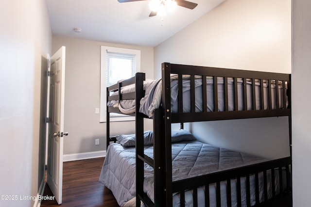 bedroom featuring ceiling fan, dark hardwood / wood-style flooring, and lofted ceiling