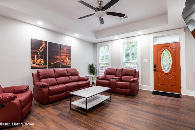 living room featuring ceiling fan and dark hardwood / wood-style flooring