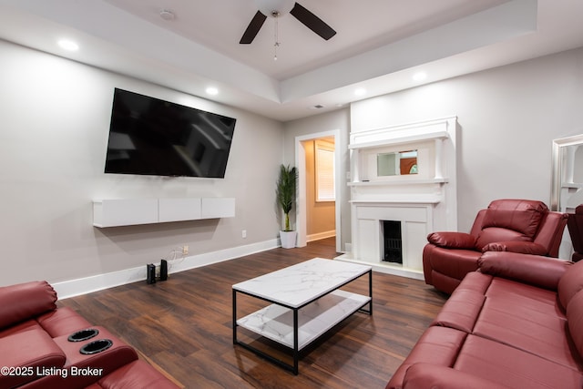 living room featuring ceiling fan and dark wood-type flooring