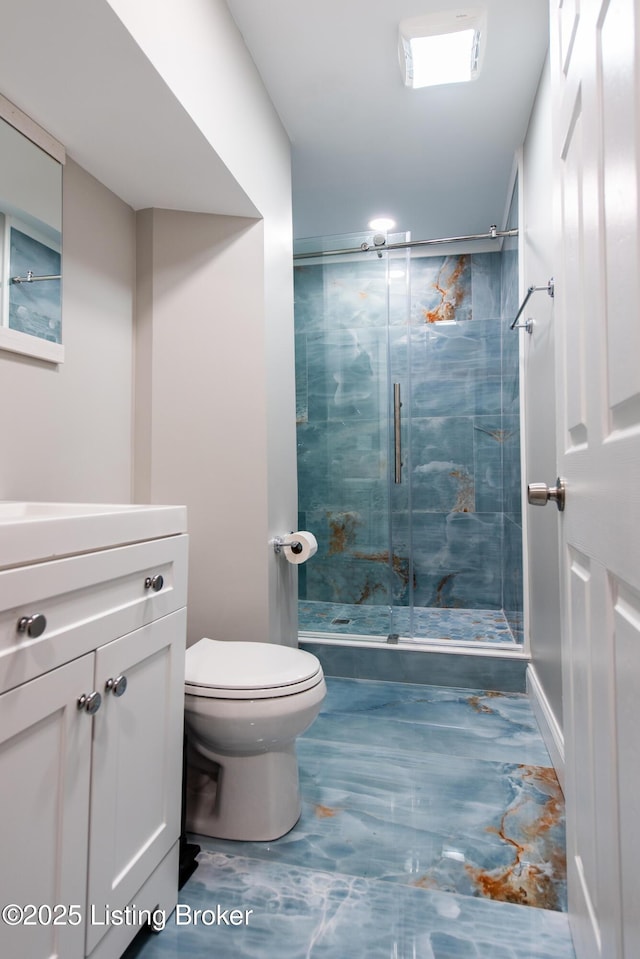 bathroom with toilet, vanity, and walk in shower