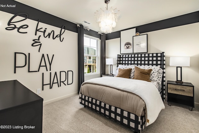 carpeted bedroom featuring an inviting chandelier