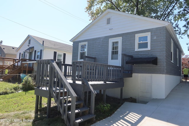 rear view of property featuring a deck