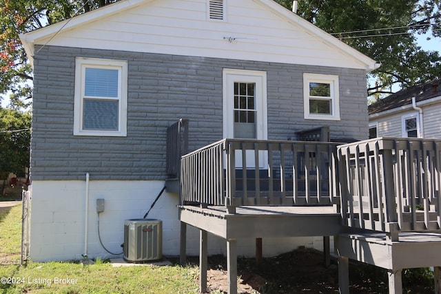 back of property featuring central air condition unit and a wooden deck