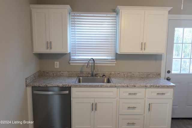 kitchen featuring dishwasher, white cabinets, and sink