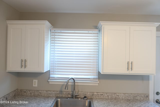 kitchen with white cabinets, a wealth of natural light, and sink