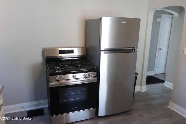 kitchen featuring appliances with stainless steel finishes and dark hardwood / wood-style floors