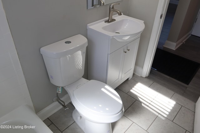 bathroom featuring tile patterned flooring, vanity, and toilet