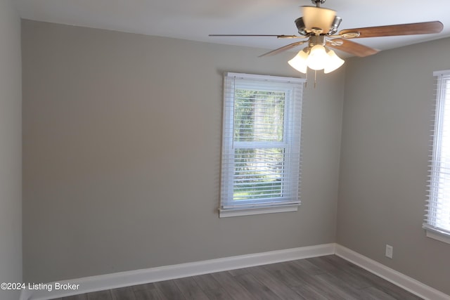 spare room with ceiling fan and dark wood-type flooring