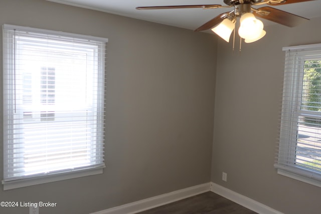 empty room with dark hardwood / wood-style floors and ceiling fan