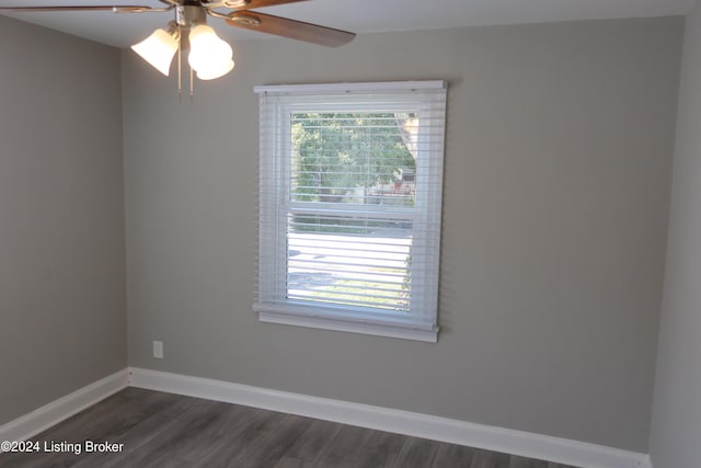 spare room with ceiling fan and dark wood-type flooring