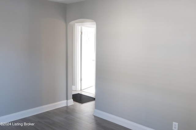 empty room with dark wood-type flooring