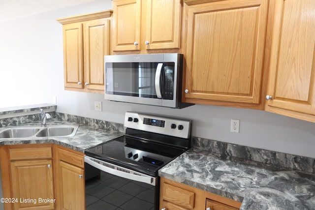 kitchen with tile patterned flooring, sink, and appliances with stainless steel finishes