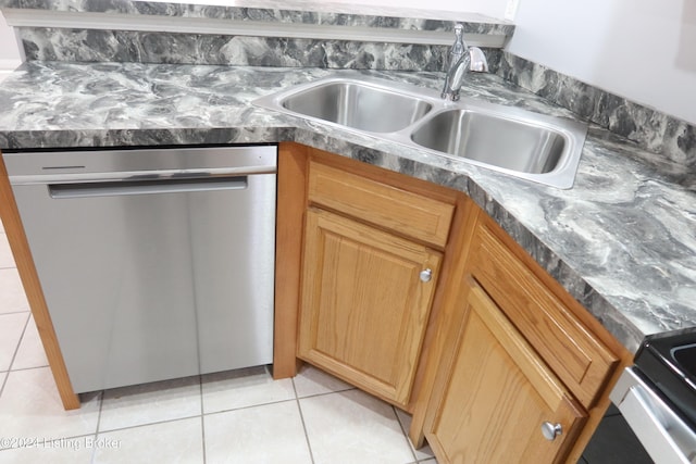 kitchen featuring dishwasher, light tile patterned floors, and sink