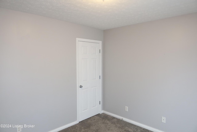 carpeted spare room featuring a textured ceiling