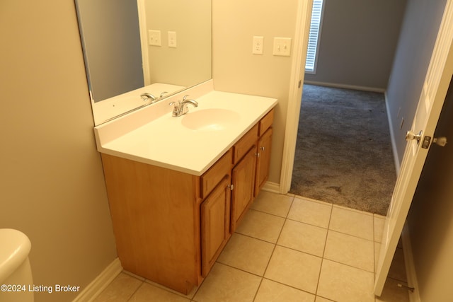 bathroom featuring toilet, vanity, and tile patterned floors