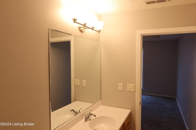 bathroom featuring vanity and a textured ceiling