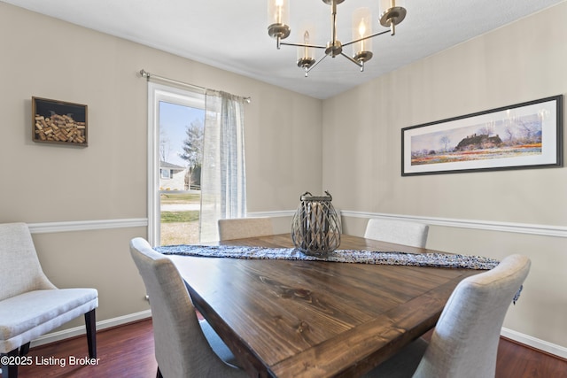 dining area featuring dark hardwood / wood-style floors and a notable chandelier