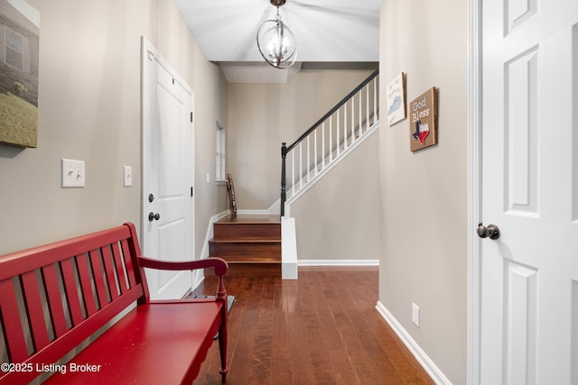 foyer featuring a notable chandelier and dark hardwood / wood-style flooring