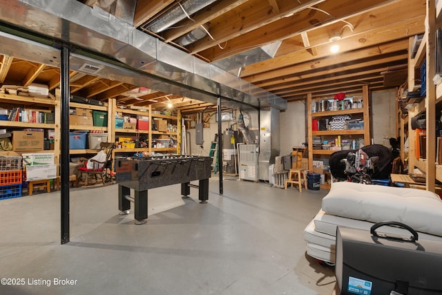 basement with water heater, heating unit, and electric panel