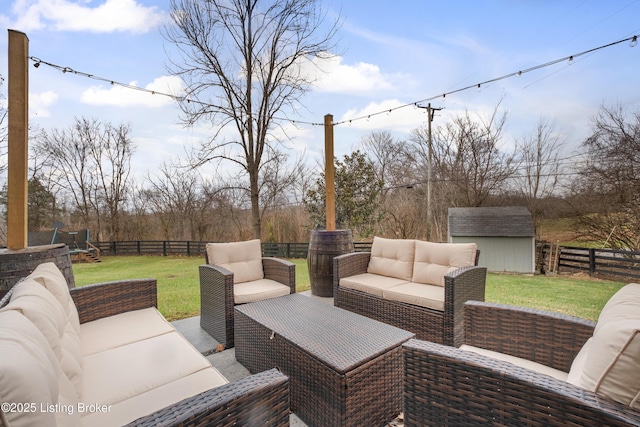 view of patio featuring an outdoor living space and a storage shed