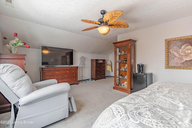 carpeted bedroom featuring a textured ceiling, ceiling fan, and lofted ceiling